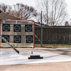 Hockey stick and pucks on ice